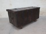 an old wooden trunk sitting on the concrete floor