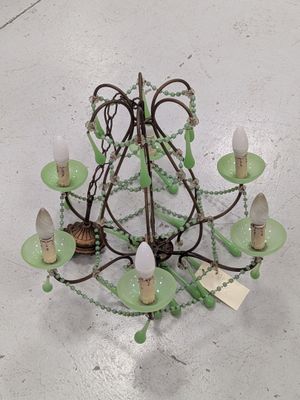 a green chandelier hanging from the ceiling in a room