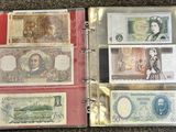 a lot of different types of paper money in a binder
