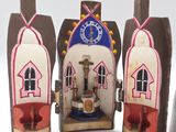 three small wooden houses with a clock on each of them