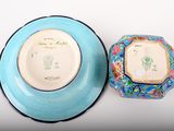 a blue bowl and a blue plate on a white table