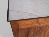 a close up of a marble top on a wooden cabinet