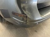 a close up of a car ' s bumper with a sticker on it