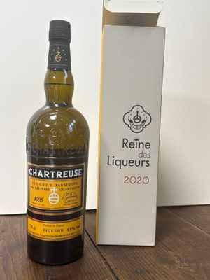 la bouteille de vin est à côté de la boîte sur la table