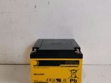 a yellow and black battery sits on a white surface