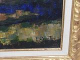 an oil painting of a landscape in a gold frame on a white wall