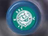 a close up view of a blue frisbee with a green label