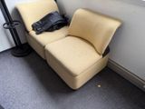 a chair that has a bag on it in the corner of a room