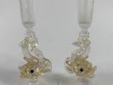 two clear glass vases with gold fish on them