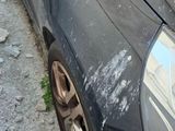 a black car that is parked on the side of the road