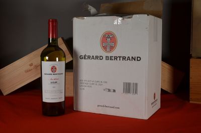 a bottle of wine sitting next to a box on a table