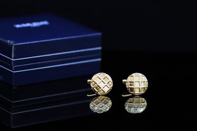 a pair of cufflinks that are sitting on a table