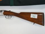 a shotgun with a wooden barrel and a case on a table