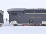 two toy trains sitting next to each other on a white surface