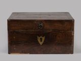 an old wooden box with a lock on top of it