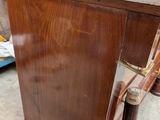 a wooden cabinet with a marble top and a metal handle
