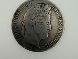 a close up of a coin on a white surface