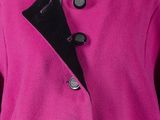 a close up of a pink coat with black buttons on a mannequin mannequin mannequin mannequin mannequin mannequin manne