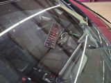 a remote control sitting on the windshield of a car