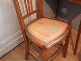 a wooden chair sitting next to a desk in a room