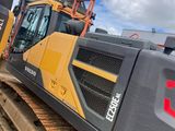 a yellow and black bulldozer parked on the side of the road
