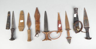 many different types of knives on a white surface