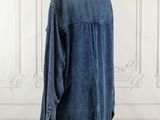 a close up of a denim shirt on a mannequin stand