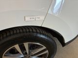 a white car with a sticker on the side of it
