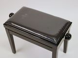 a small black stool with a black seat on a white surface