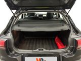 the back of a car with the trunk open and a red umbrella in the trunk