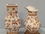 two vases that are sitting next to each other on a table