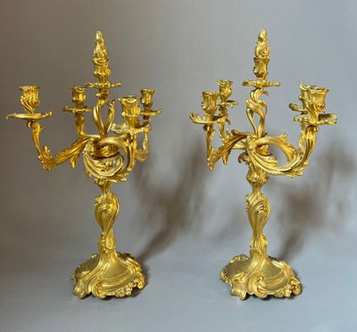 pair of antique brass candelabs with flowers and birds on them
