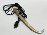 a long horn with a rope on it on a white surface