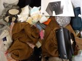 a pile of clothes and other items in a suitcase