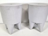 pair of concrete stools with legs and feet