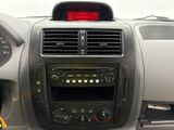 a dashboard of a car with a clock and radio in it
