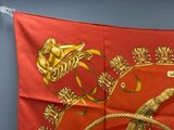 an image of a red scarf with a gold design