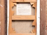 an old picture frame with a piece of paper and a piece of wood