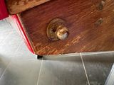 a close up of a piece of wood on the floor of a bathroom