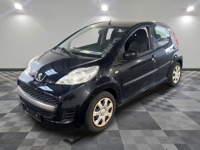 a picture of a small black car on a checkered floor