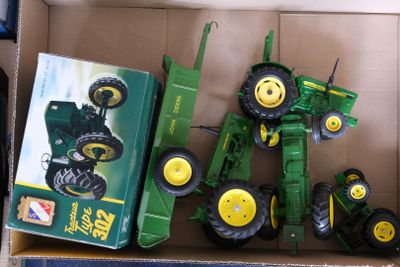 a box with a toy tractor and a box with a toy tractor in it