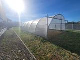 a large greenhouse in the middle of a field