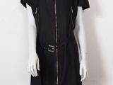 un mannequin portant une robe noire avec une fermeture éclair sur le devant