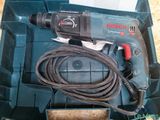 a corded drill in a blue box with a cord