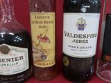 several bottles of wine are lined up on a red surface