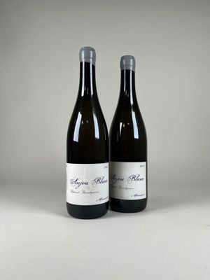 two bottles of wine sitting next to each other on a table