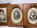 three framed photographs of a young boy and a girl in formal clothes