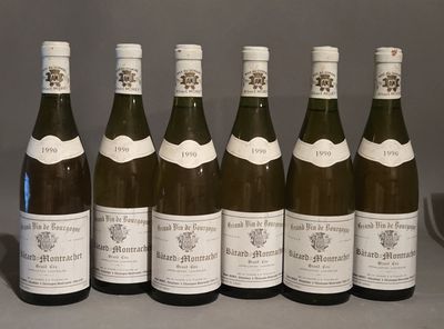 six bottles of wine are lined up in a row on a table