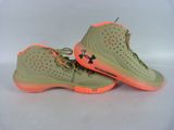 a pair of green and orange shoes on a white surface