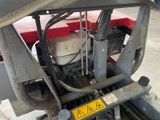 a close up of the engine of a red tractor